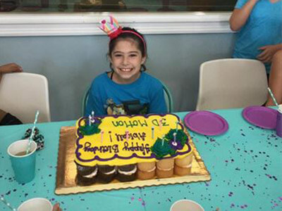 Birthday girl with her cake