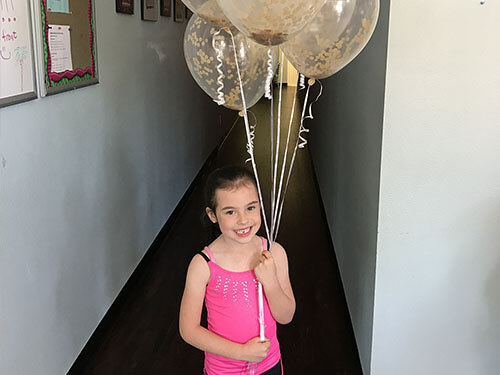 Birthday girl holding balloon